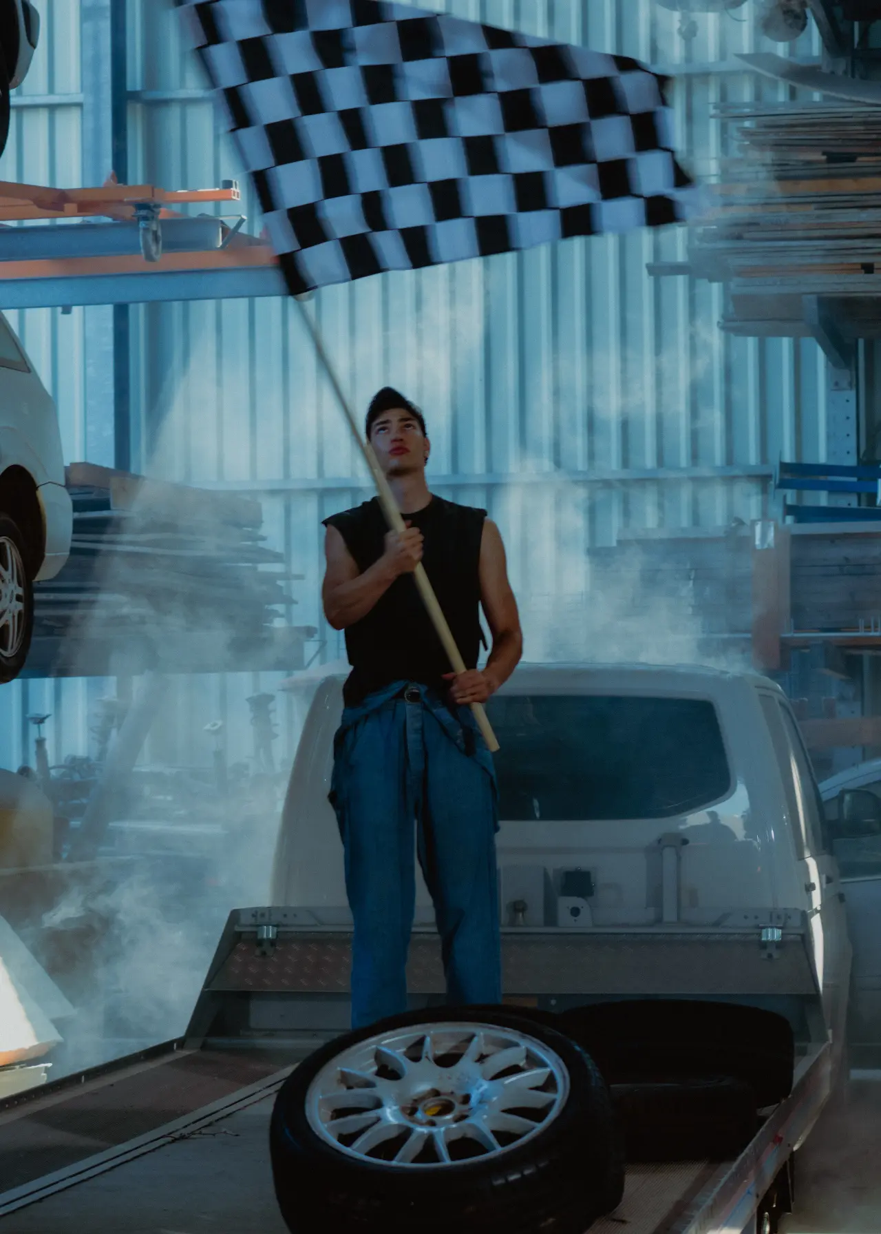 Person inspecting equipment beside a vehicle