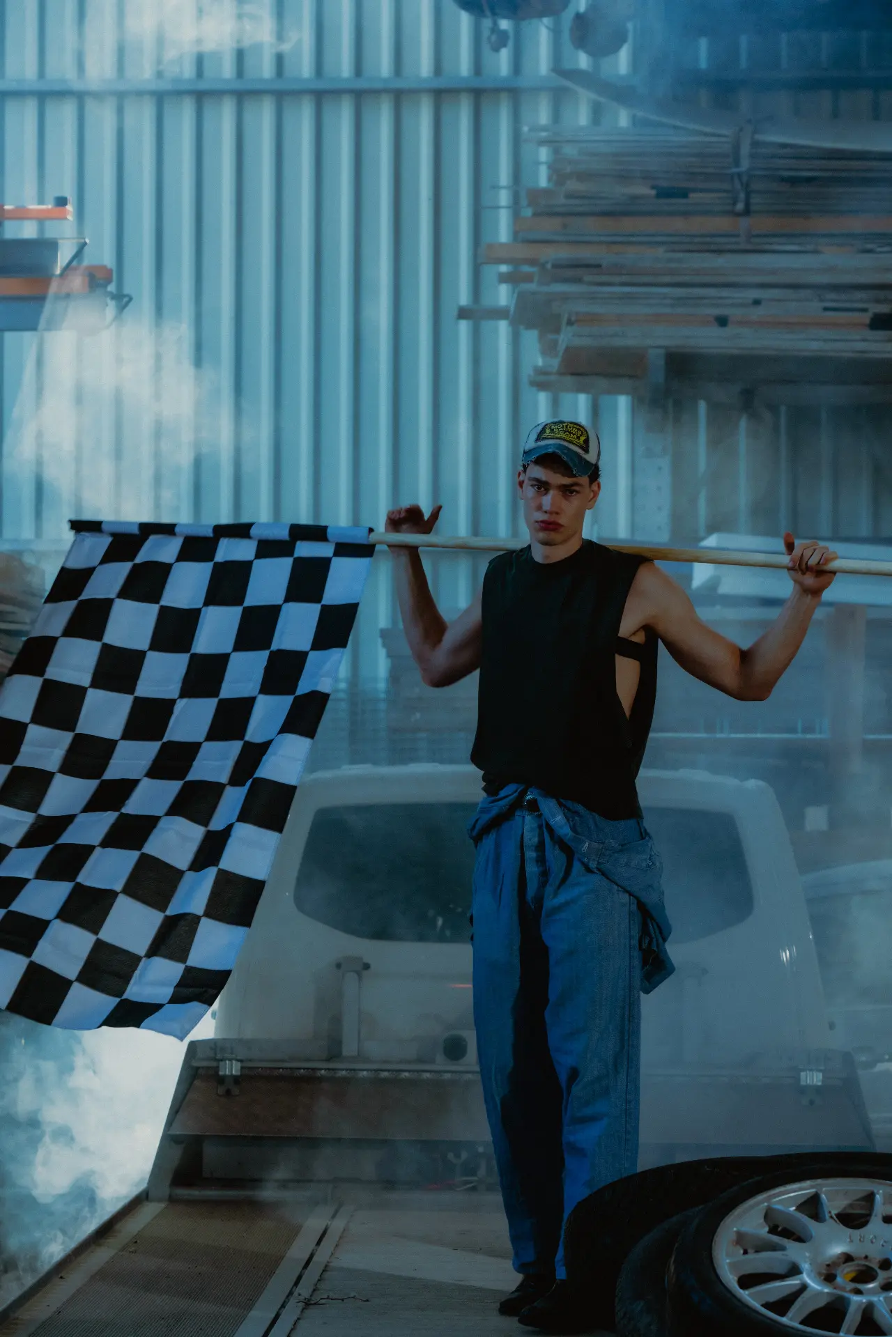 Checkered flag held in an automotive workshop